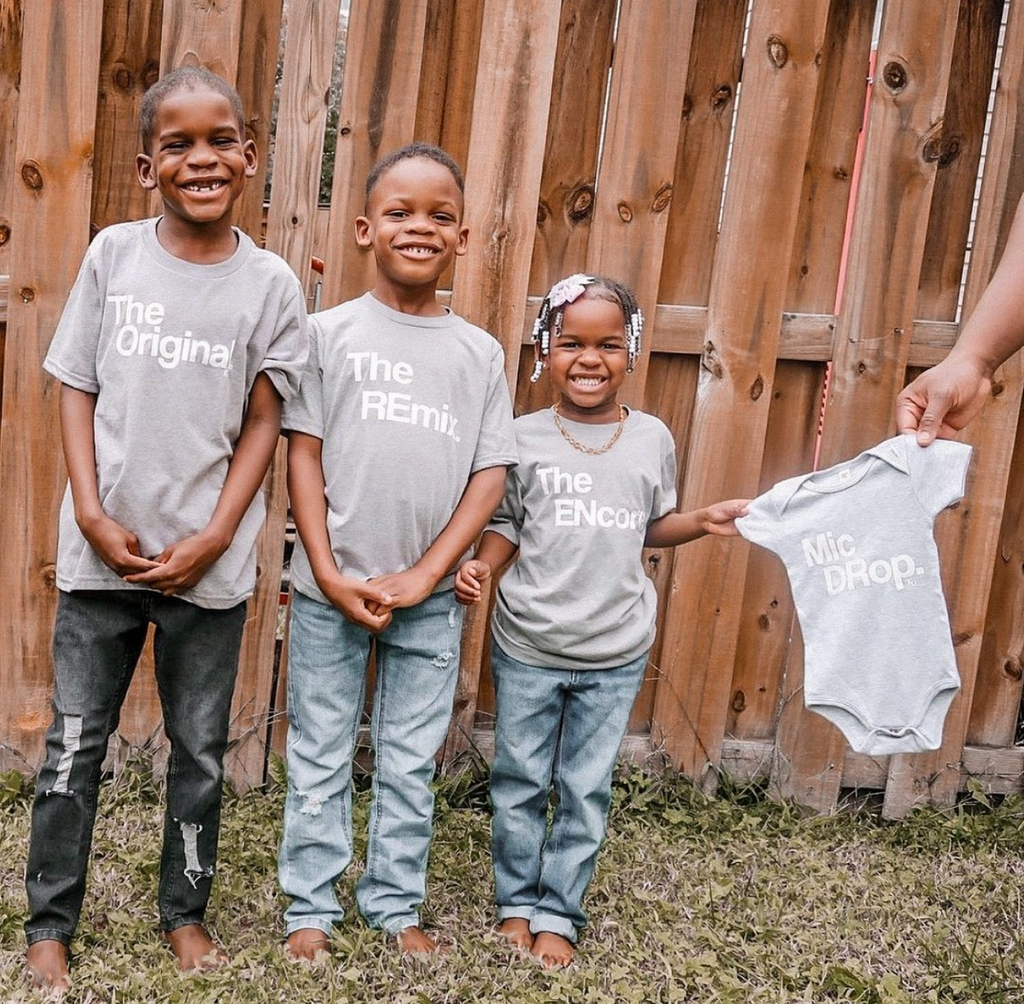 kids wearing heather grey for pregnancy announcement shirts with a newborn onesie