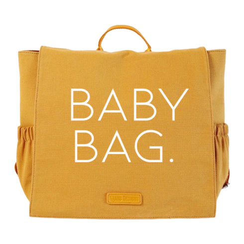 butterscotch bag with canvas material and vegan leather handle that says baby bag