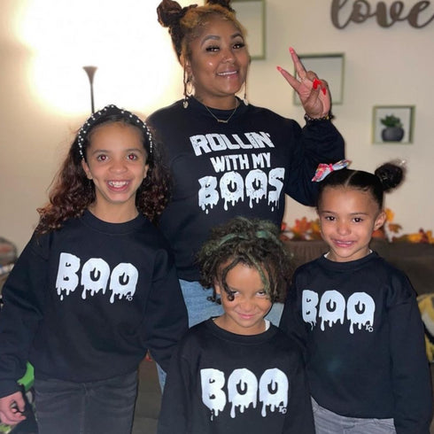 mom matching with 3 kids in halloween sweatshirt sets for halloween