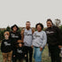 family taking christmas photos at a tree farm in matching shirts