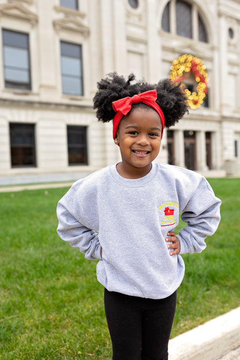 christmas themed holiday sweatshirt shows kevins battle plan from home alone with an embroidered design of a house on the front.
