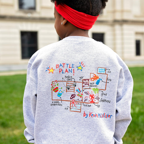 christmas themed holiday sweatshirt shows kevins battle plan from home alone with an embroidered design of a house on the front.