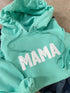 flat lay of hoodie ocean blue color with a distressed mama screen print design cute and cozy hoodie for women or mothers