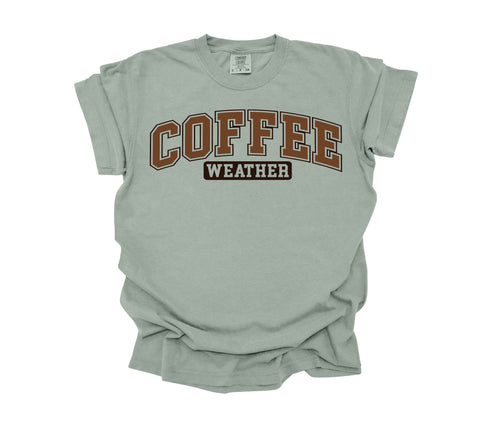 sage color t-shirt that is comfort colors with design that says coffee weather in crew neck shirt.