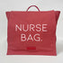 coral color bag back pack that says nurse bag on the front flap
