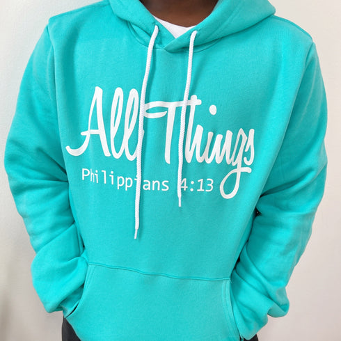teen wearing inspring hoodie in teal color that is referencing scripture in the bible Philippians 4:13 I can do all things through christ who strengthens me.