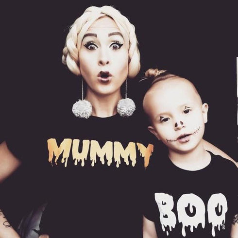 mom and son matching in halloween shirts mummy and boo looking like zombies with son wearing fun halloween makeup face like a skeleton