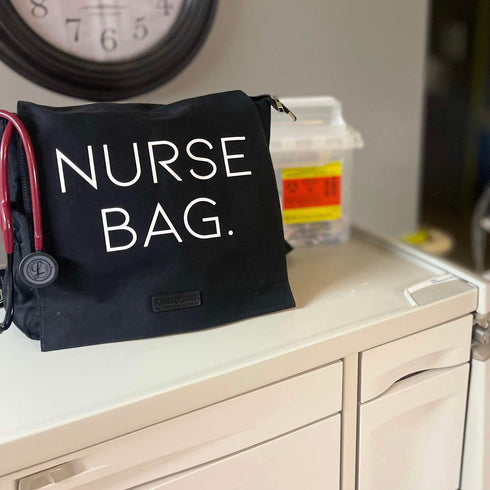 black bag with lots of pockets that says nurse bag on the front flap