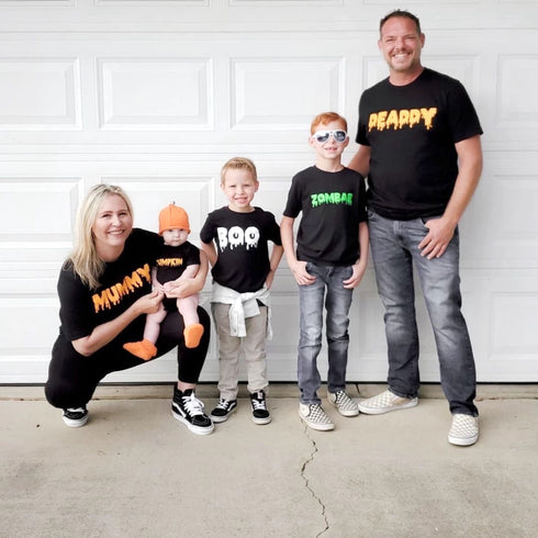 family of five in front of a garage in halloween matching shirts
