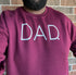 maroon photo of dad with a beard, sweatshirt pullover with black dad wearing it