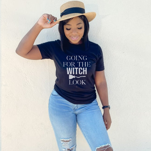 black women in fedora hat wearing unisex white and orange ink shirt with halloween themed screen print design that says going for the