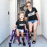 christina smallwood in front of home with daughter that has cerebral palsey wearing matching shirts that say moms and shorty for a cute mommy and me set